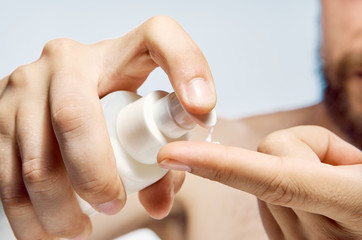 man close-up squeezes foam on his finger
