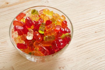 gummy bears on wooden background