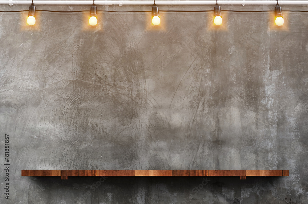 Fototapete empty brown wood plank board shelf at grunge concrete wall with light bulb string party background,m