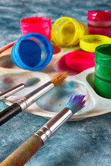 Gouache paints and art brushes for the artist with a copy space