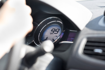 Car speedometr, black and chrome, selective focus. speed is 99