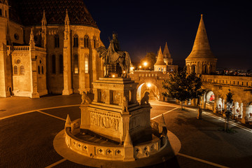 City of Budapest in Hungary at night, King St. Stephen (1906) monument, Matthias Church and...