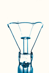 close up tungsten bulb core wire vintage light bulb blue on white background