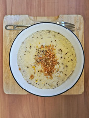 Top view of Asian style steam egg with garlic and pepper. Served on wooden chopping board