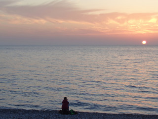 Watching sunset at the sea coast