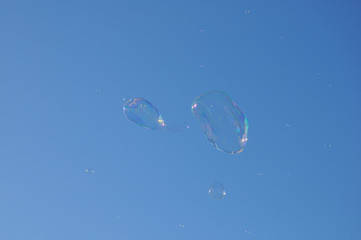 Two bubbles from the bubble blower floating on the sky