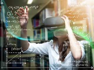 Asian woman wearing virtual reality glasses or VR headset and learning from technology. woman getting experience using VR-