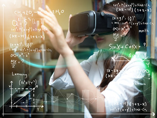 Asian woman wearing virtual reality glasses or VR headset and learning from technology. woman getting experience using VR-