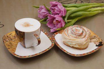 Coffee, bun and flower