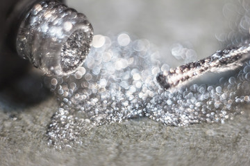 Texture of shiny nail polish shine closeup.a bottle of nail polish next to the brush.