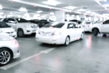 Fototapeta na wymiar Blured image of Many cars in parking garage interior, industrial building