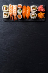 Overhead shot of Japanese sushi on black concrete background © Leszek Czerwonka