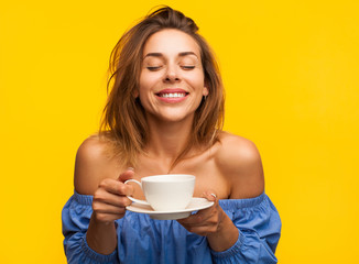 Smiling woman enjoying coffee