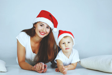 happy mother and baby in red Christmas hats