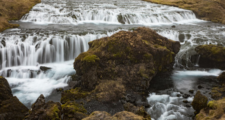 Landscape with Kvernfoss Waterfall near Skogar, Iceland at with blurred falls at slow shutter speed