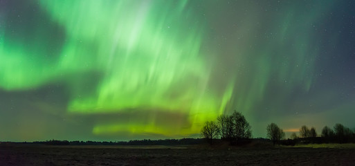 Green Aurora Borealis over night sky
