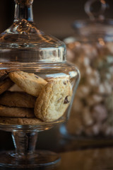 Oatmeal cookie in glass jar, closeup photo