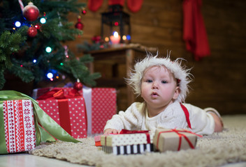 Fototapeta na wymiar Baby six months under the Christmas tree