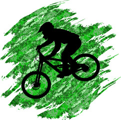 Silhouette of a cyclist going down on a mountain bike on a slope