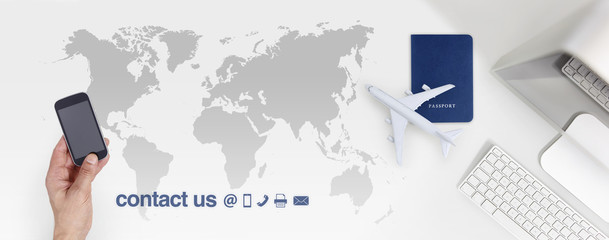 contact us and booking flight ticket air travel vacations concept, hands with smart phone on world map background