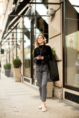Young woman on the street with mobile phone