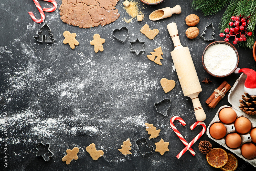 Wall mural Baking christmas cookies on grey wooden table