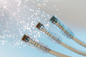 Closeup of RJ45 UTP LAN on the background of optical fibers with blurred lights