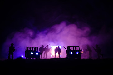 Obraz na płótnie Canvas War Concept. Military silhouettes fighting scene on war fog sky background, World War Soldiers Silhouettes Below Cloudy Skyline At night. Attack scene. Army jeep vehicles with soldiers.