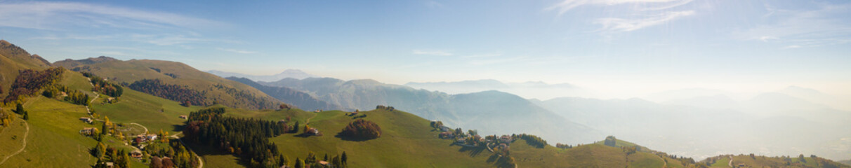 Landscape on hills and Orobie mountains with humidity in the air and pollution. Panorama from Farno Mountain, Bergamo, Italy
