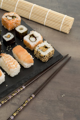 Set of sushi and chopsticks, traditional asian dishes.