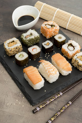 Set of sushi and chopsticks, traditional asian dishes.
