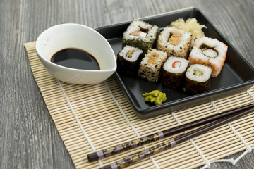 Set of sushi and chopsticks, traditional asian dishes.