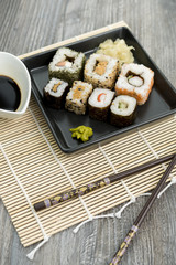 Set of sushi and chopsticks, traditional asian dishes.
