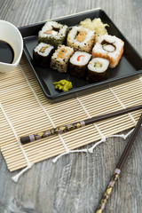 Set of sushi and chopsticks, traditional asian dishes.