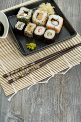 Set of sushi and chopsticks, traditional asian dishes.
