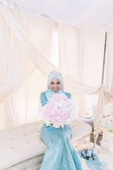 head shot portrait or close up of a beautiful Asian woman in hijab and wedding dress