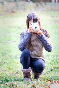 happy little girl taking photos outdoors