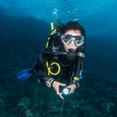 woman scuba diving on a tropical reef in the Philippines