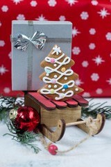 Gingerbread Christmas tree and gift on wooden sledge