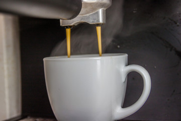 Close-up of hot coffee from coffee machine.