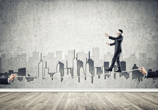 Business concept of risk support and assistance with man balancing on rope