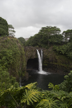 Hawaiian Rainbow Falls pouring into a serene blue pool