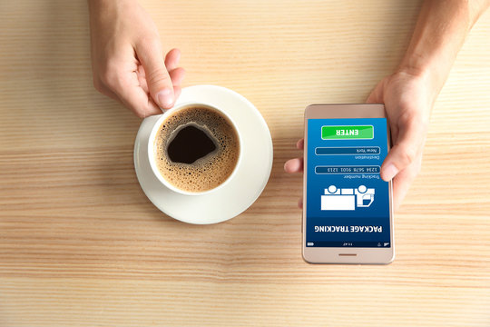 Man using smart phone in cafe - Powered by Adobe