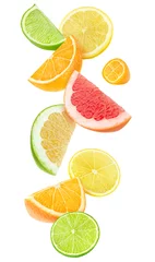 Peel and stick wall murals Fruits Isolated citrus fruits pieces in the air. Sliced orange, lemon, lime, grapefruit and kumquat falling isolated on white background with clipping path