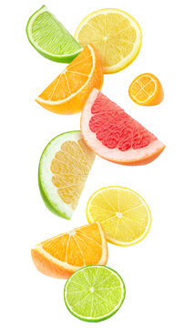 Isolated citrus fruits pieces in the air. Sliced orange, lemon, lime, grapefruit and kumquat falling isolated on white background with clipping path