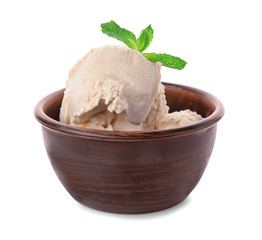 Bowl with caramel ice cream on white background