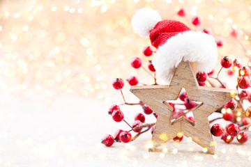Obraz na płótnie Canvas Christmas background. Christmas star and santa hat. Greeting card.