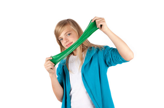 Girl playing with green slime. Isolated on white background.