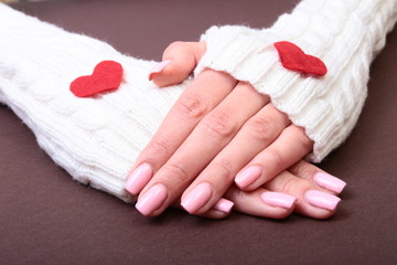 Female hands giving red heart, isolated on gold background