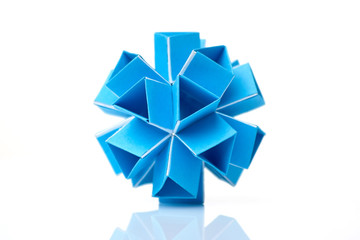 Blue kusudama model on white. Amazing geometry of origami creation. Japanese art of folding paper.